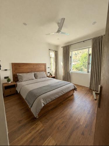 a bedroom with a large bed and a window at Haven Retreat in Srinagar
