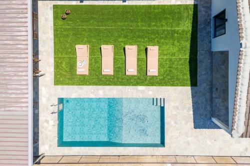 an overhead view of a swimming pool and a yard at Villa Theofilos in Glossa