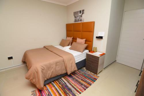 a bedroom with a large bed and a rug at TALITHA'S SELF-CATERING ACCOMMODATION in Walvis Bay