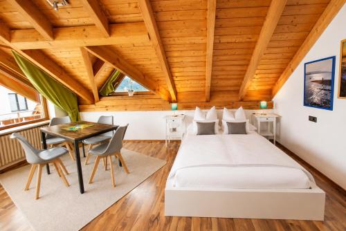 a bedroom with a bed and a table and chairs at Haus Rose in Allensbach