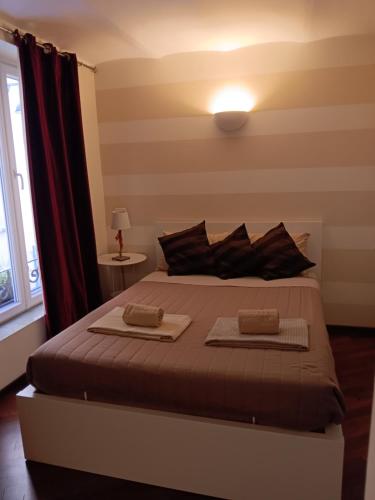 a bedroom with a bed with two towels on it at Splendido Bilocale in Savona