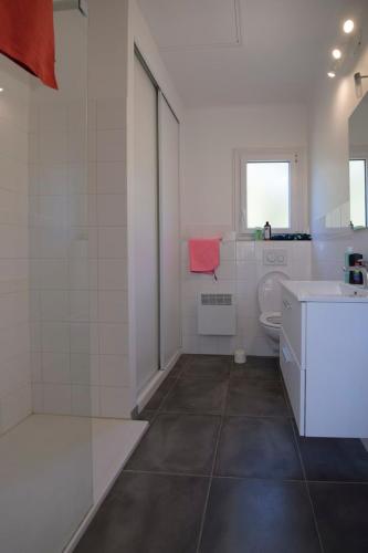 a white bathroom with a toilet and a sink at Sélection Camping La Croix -Valmer in La Croix-Valmer