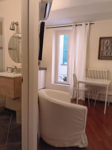 a bathroom with a tub and a sink and a window at Splendido Bilocale in Savona