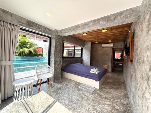 a bedroom with a bed and a table and chairs at Big leaf villa kohsamui in Bangrak Beach