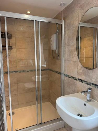 a bathroom with a shower and a sink at Modern peaceful property Breakfast included in Blean