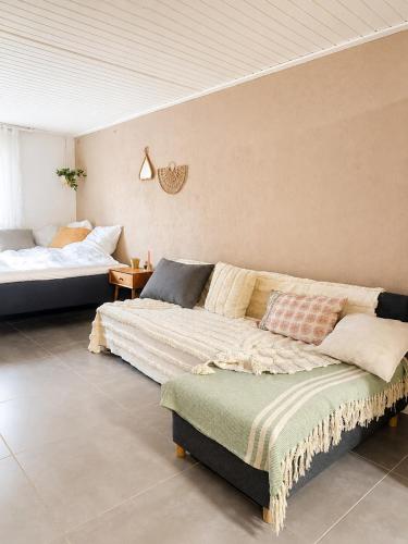 a living room with a couch and a bed at Quiet and charming studio apartment in Vejle
