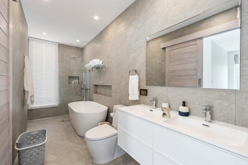 a bathroom with a white sink and a toilet at Mountain and Sea view apartment in Nathon Bay