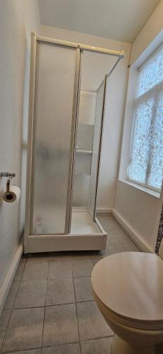 a shower with a glass door in a bathroom at Vårsol Overnatting i Vardø centrum in Vardø