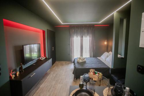a small room with a bed and a television at Skyline suite studio in Larisa