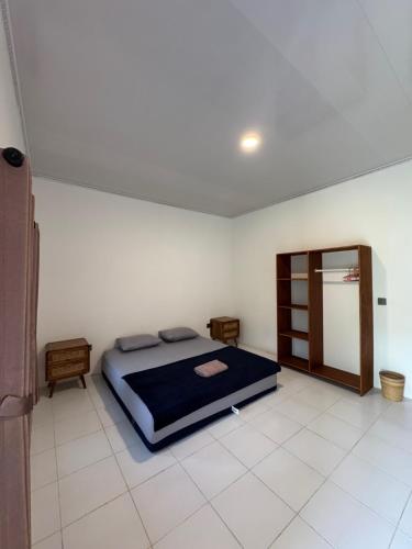 a bedroom with a bed and a mirror in it at JHOB Surf Stay in Maluk