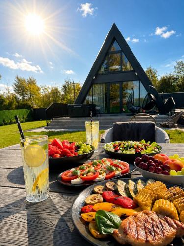a table with many plates of food on it at Nikis House Luxury Pool - Spa Villa in Ba°evac