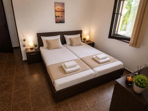 a bedroom with a large bed with two pillows on it at Хотел Свети Димитър in Sozopol