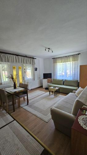 a living room with a couch and a table at Apartman Marija in Zlatibor