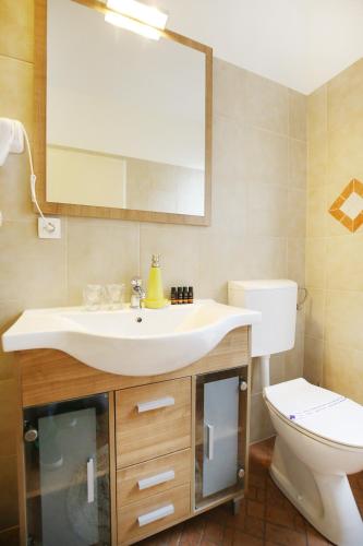 a bathroom with a sink and a toilet and a mirror at Allegro Exclusive Suites Old Town Center in Zadar