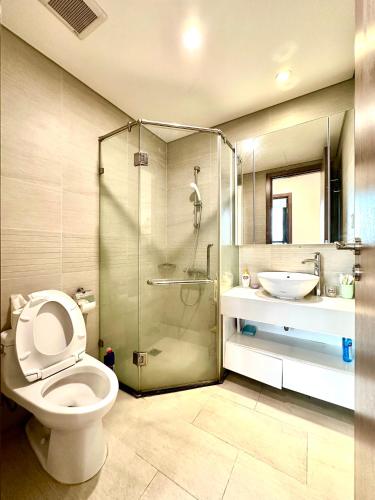 a bathroom with a shower and a toilet and a sink at Cozy Skyline Escape 2Bedroom Near Hanoi Major Business District in Hanoi