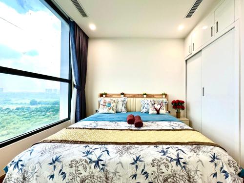 a bedroom with a bed with a large window at Cozy Skyline Escape 2Bedroom Near Hanoi Major Business District in Hanoi