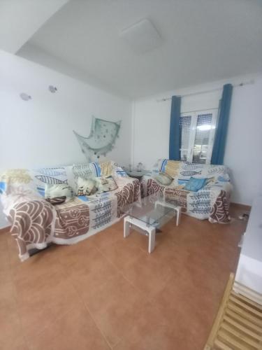 a living room with two couches and a table at Relax Pinares in Lepe