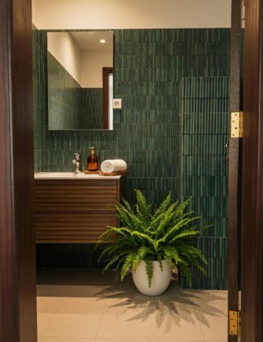 a bathroom with a sink and a potted plant at The Hills in Accra