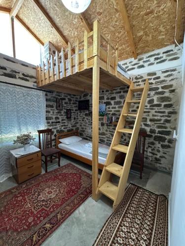 a bedroom with a bunk bed in a room at Stone House in Këlcyrë