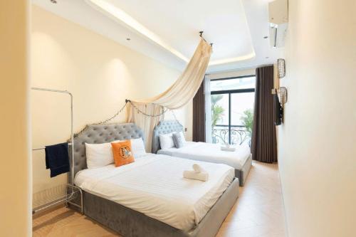 a bedroom with two beds and a window at Homestay Beauty D1 in Ho Chi Minh City