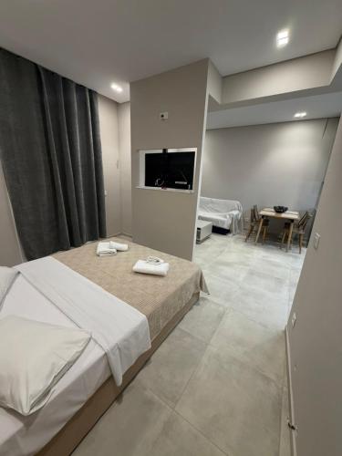a bedroom with a bed and a table and a television at HOME stay in Itea