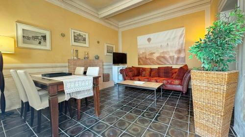 a living room with a couch and a table at I mille Tramonti di Ilaria in Livorno