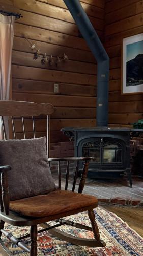a chair sitting in a room with a fireplace at ログbase in Kaga