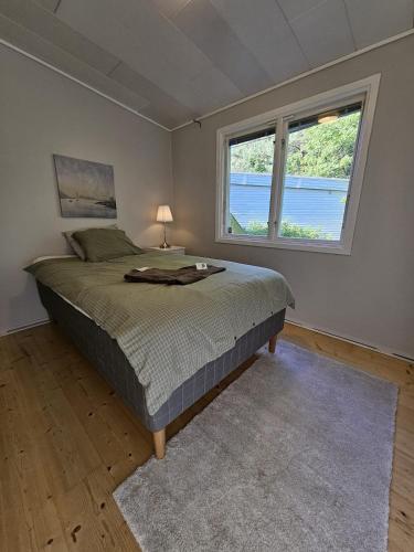 a bedroom with a bed and a large window at Spacious villa in Sörby in Gävle