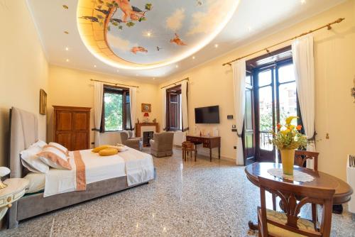 a bedroom with a bed and a living room at VILLA AGOSTINO LUXURY B&b in Vico Equense
