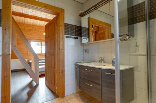 a small kitchen with a sink and a staircase at Waldsiedlung - Haus 10 in Großkoschen