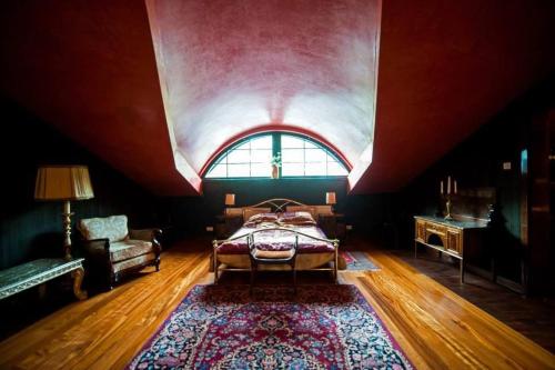 a bedroom with a bed and a large window at Nostalgia in Sokolniki