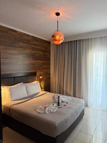 a bedroom with a bed and a pendant light at Ktima Papaoikonomou in Potos