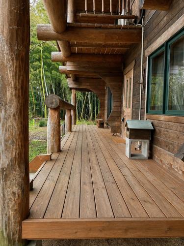 a wooden deck on the side of a cabin at ログbase in Kaga