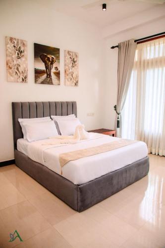 a bedroom with a large bed in a room at Harohi Hotel and Residence in Negombo
