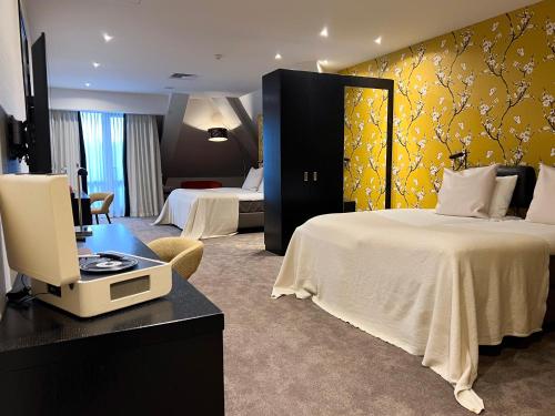 a hotel room with a bed and a desk with a computer at Van der Valk Hotel Harderwijk op de Veluwe in Harderwijk