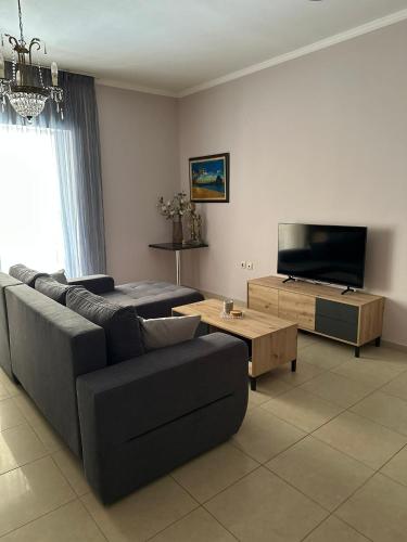 a living room with a couch and a flat screen tv at Artistic Retreat in Nafplio