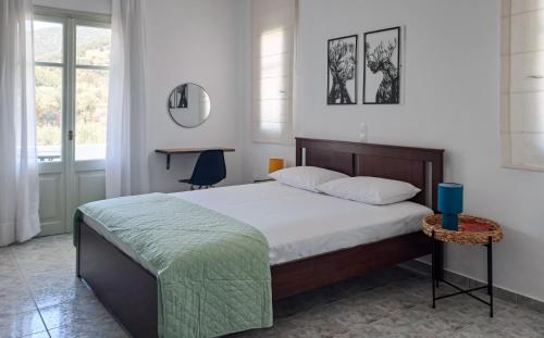 a bedroom with a large bed and a mirror at Firogia Olive Grove Hideaway in Sifnos