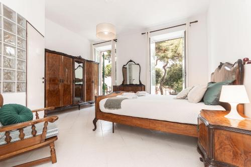 a bedroom with a large bed and windows at "Fiordolce" a due passi dal mare in Vado Ligure