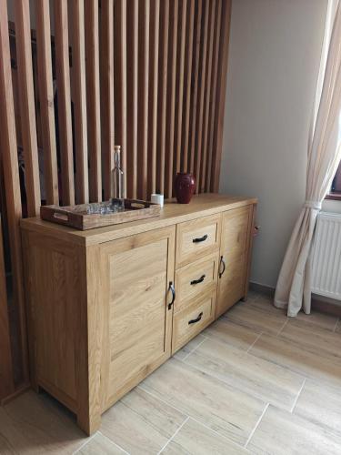 a wooden cabinet with a sink in a room at Gyulak Guesthouse in Izvoare