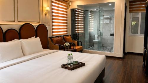 a bedroom with a bed and a glass shower at The 39 Lane Hotel Hanoi in Hanoi