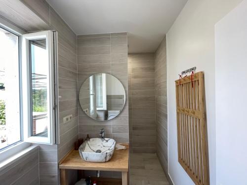 a bathroom with a sink and a mirror at Frida in VeliGolji