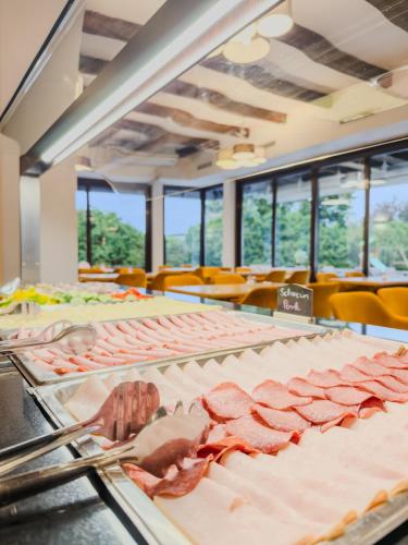 a buffet with lots of meat on display at Hotel Sachsengang - free parking, near U1 & U2 in Groß-Enzersdorf