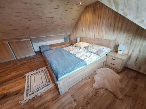 a bedroom with a bed and a wooden floor at Apartmán Bianka in Rabča