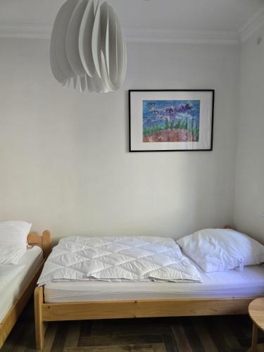 a bed in a room with a picture on the wall at Villa Beckurts in Wernigerode