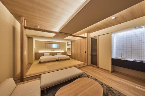 a master bedroom with a bed and a window at Yuno Yado Shoei in Kyoto