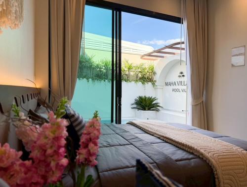 a bedroom with a bed and a large window at Villa Mar Pool Villa in Sathani Hat Yai