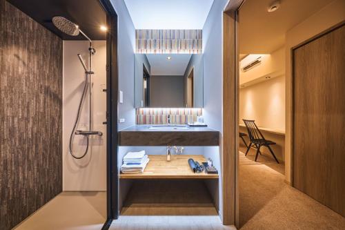 a bathroom with a sink and a shower at Yuno Yado Shoei in Kyoto