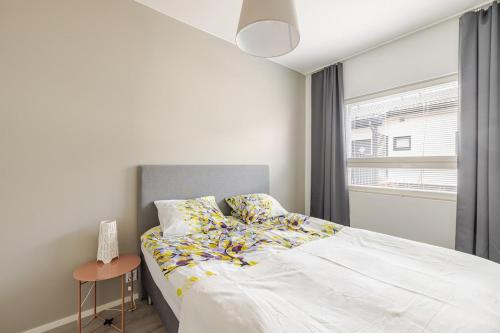 ein Schlafzimmer mit einem weißen Bett und einem Fenster in der Unterkunft Terva23 in Hämeenlinna