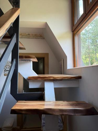 a room with wooden shelves and a window at Zelena dolina Zminica in Zminica