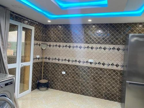 a bathroom with a blue light on the ceiling at Perle de Soliman Plage in Soliman